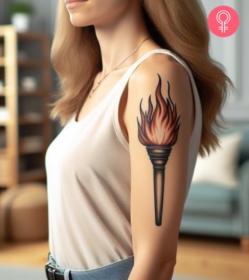 Woman with a Baphomet head tattoo on the upper arm