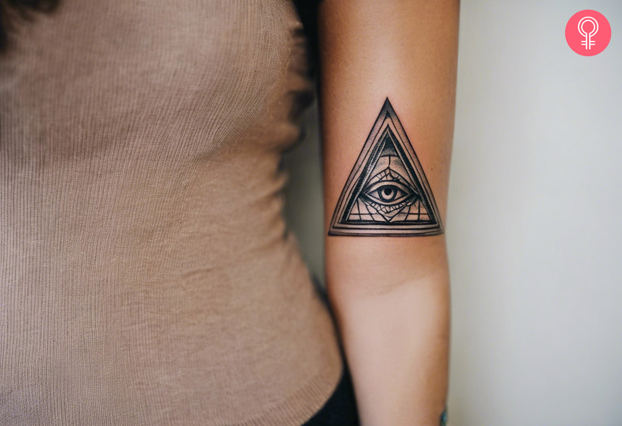 A traditional Illuminati tattoo on the upper arm