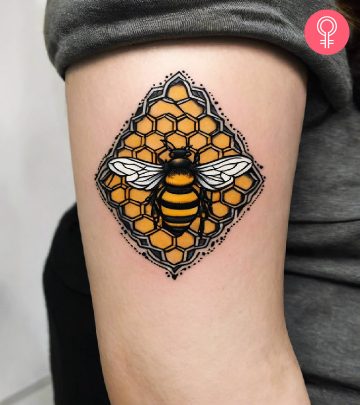 A fine line geometrical hexagon tattoo on the upper arm