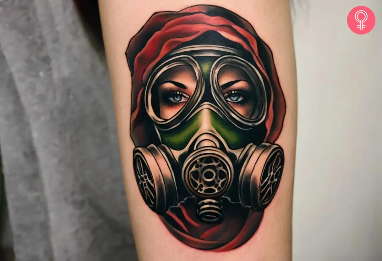 A traditional gas mask tattoo on the upper arm of a woman