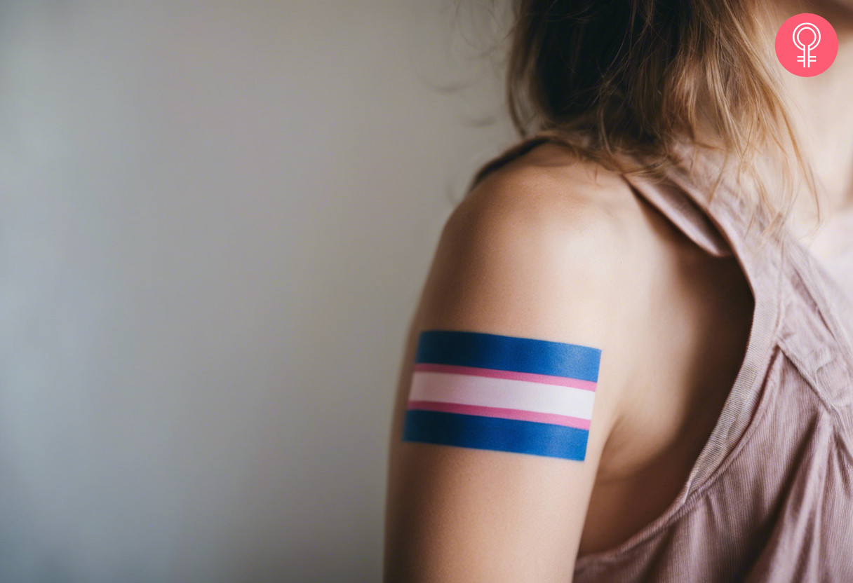 A trans flag tattoo with blue, pink, and white colored inks