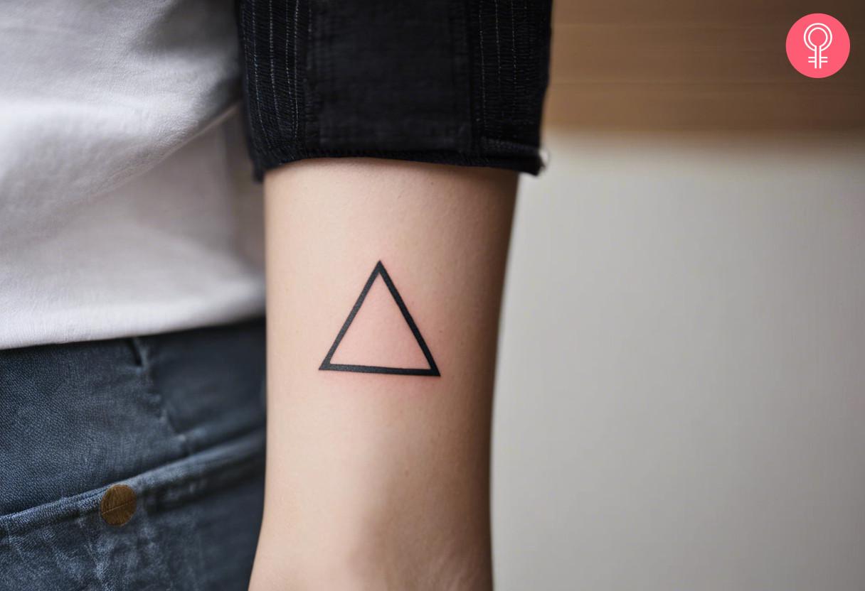 A triangle tattoo on a woman's arm