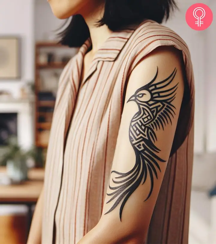 A tribal phoenix tattoo on the arm