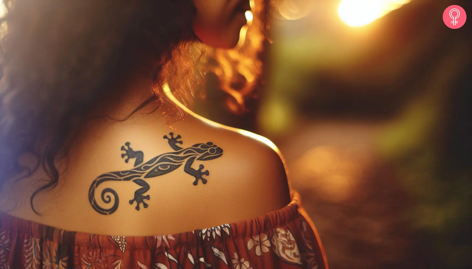 A tribal salamander tattoo on the upper back of a woman