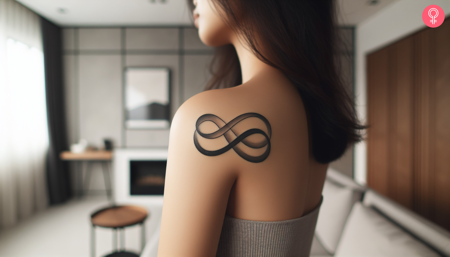 A unique double infinity tattoo on the back of the shoulder