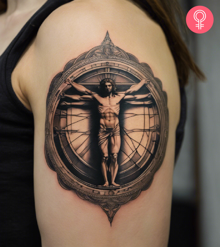 A vitruvian man tattoo on the upper arm of a woman