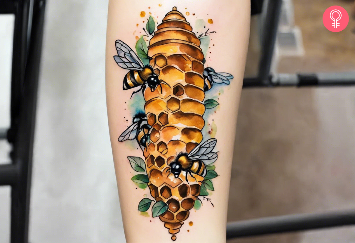 A watercolor beehive tattoo on the forearm of a woman