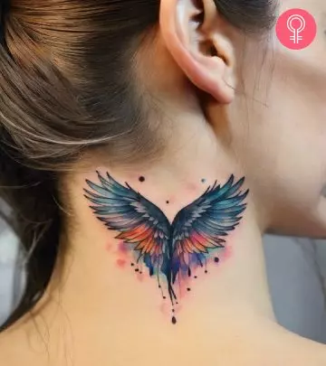 A woman with a wings tattoo design on upper arm.