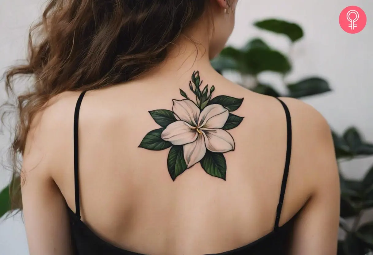 A woman wearing a gardenia flower tattoo on the back