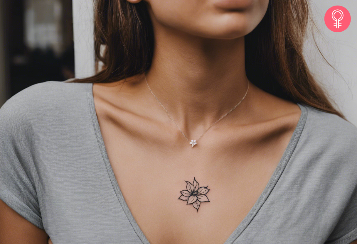 A woman wearing a simple gardenia flower tattoo on her upper chest