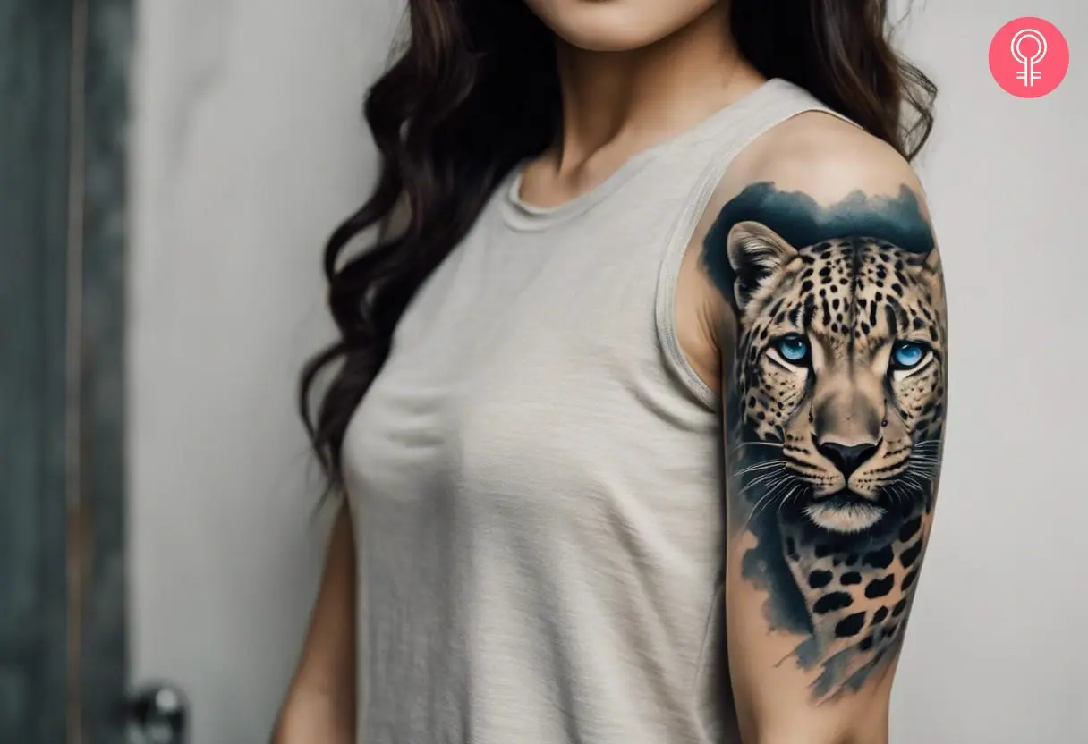 A woman wearing a snow leopard tattoo with blue eyes