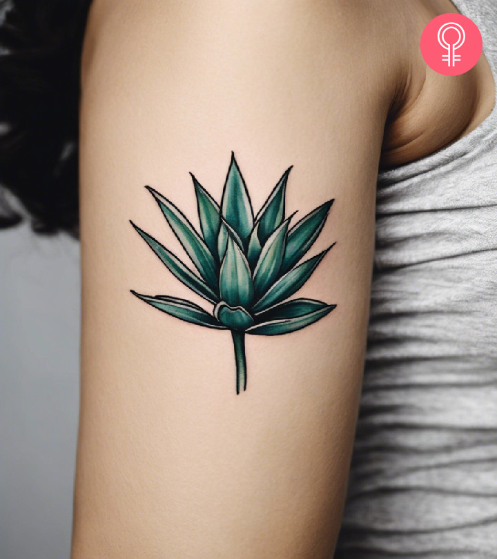 A woman wearing an agave plant tattoo on the upper arm