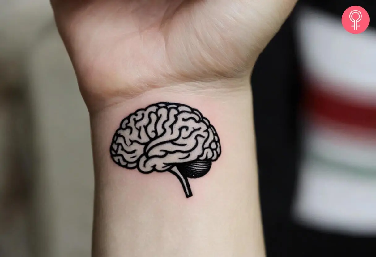 A woman wearing anatomical brain tattoo on the inner wrist