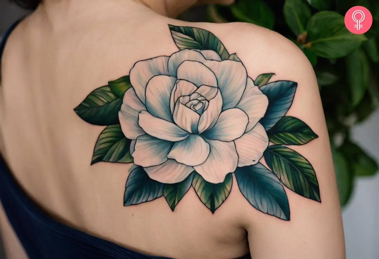 A woman wearing gardenia tattoo on her shoulder