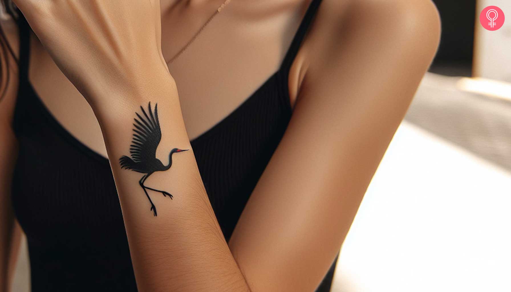 A woman with a Japanese crane tattoo on her wrist