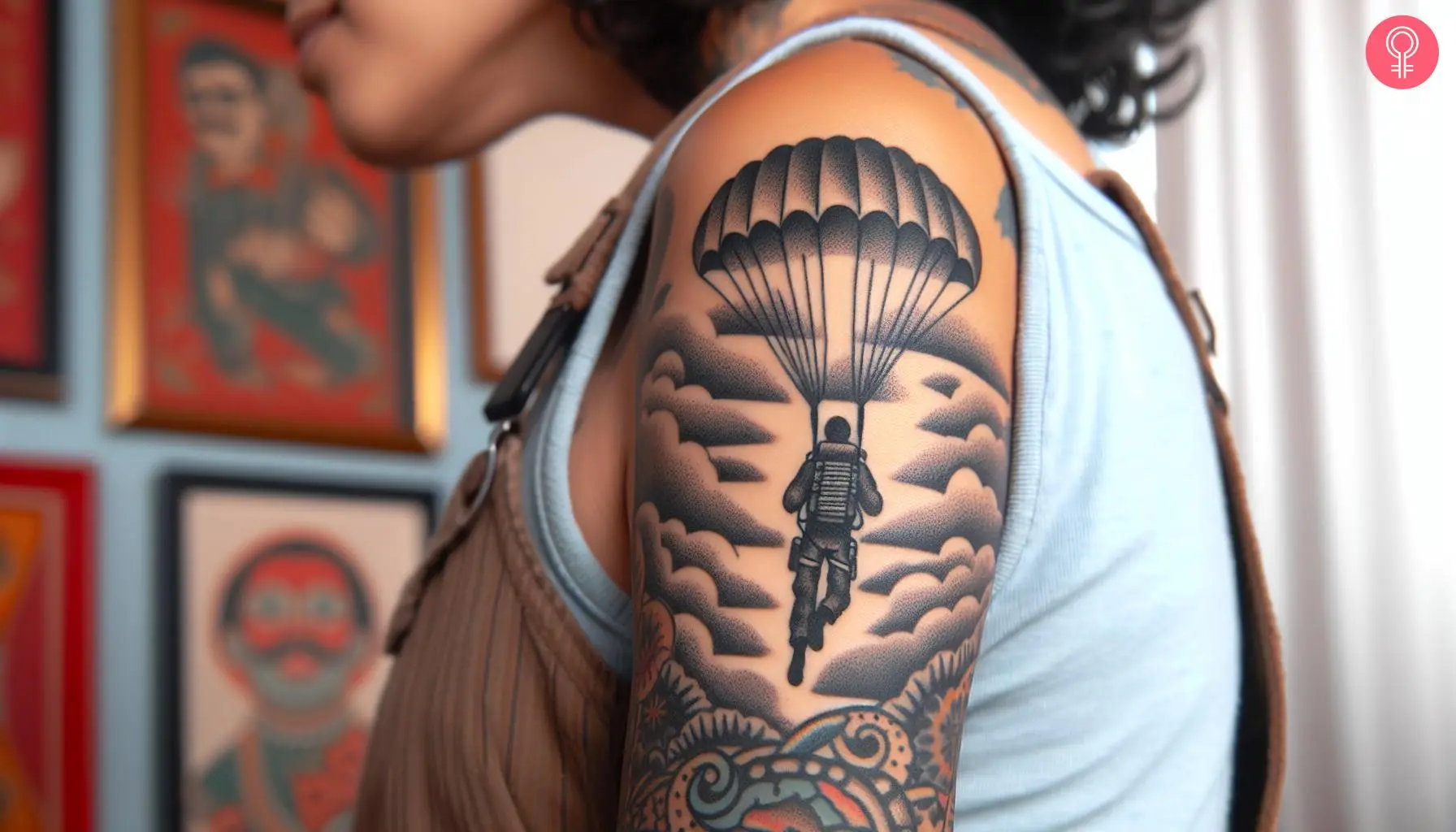 A woman with a black airborne with parachute jumping tattoo on her upper arm