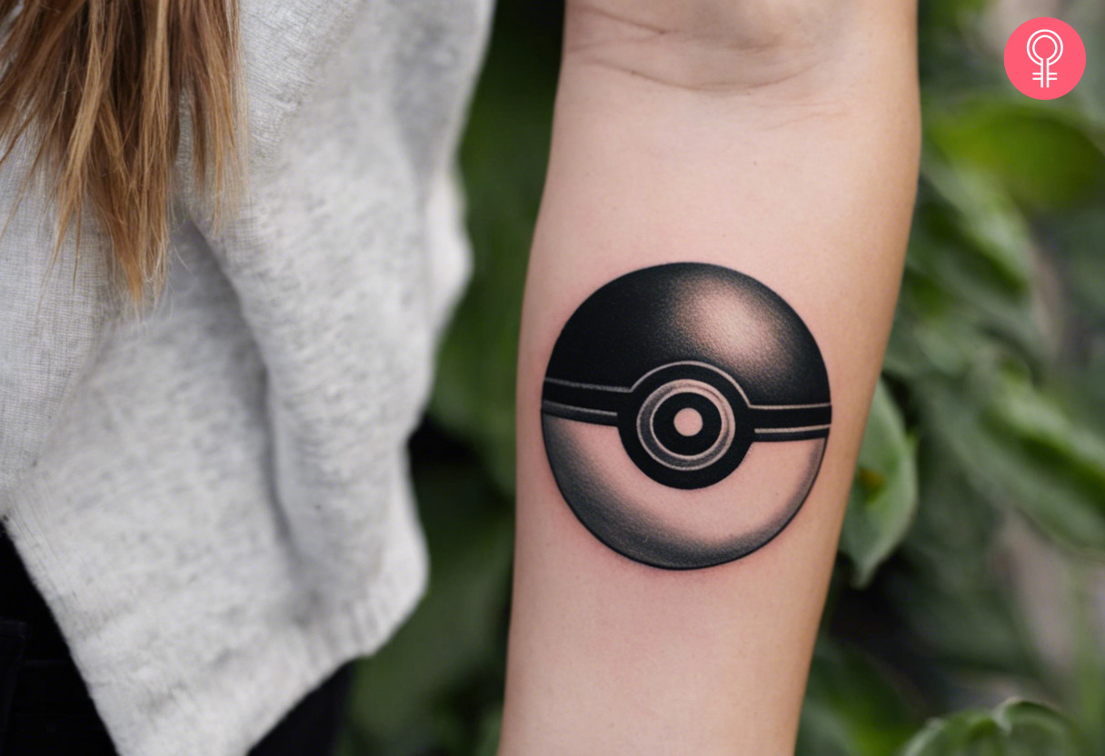 A woman with a black and white pokeball tattoo on her arm