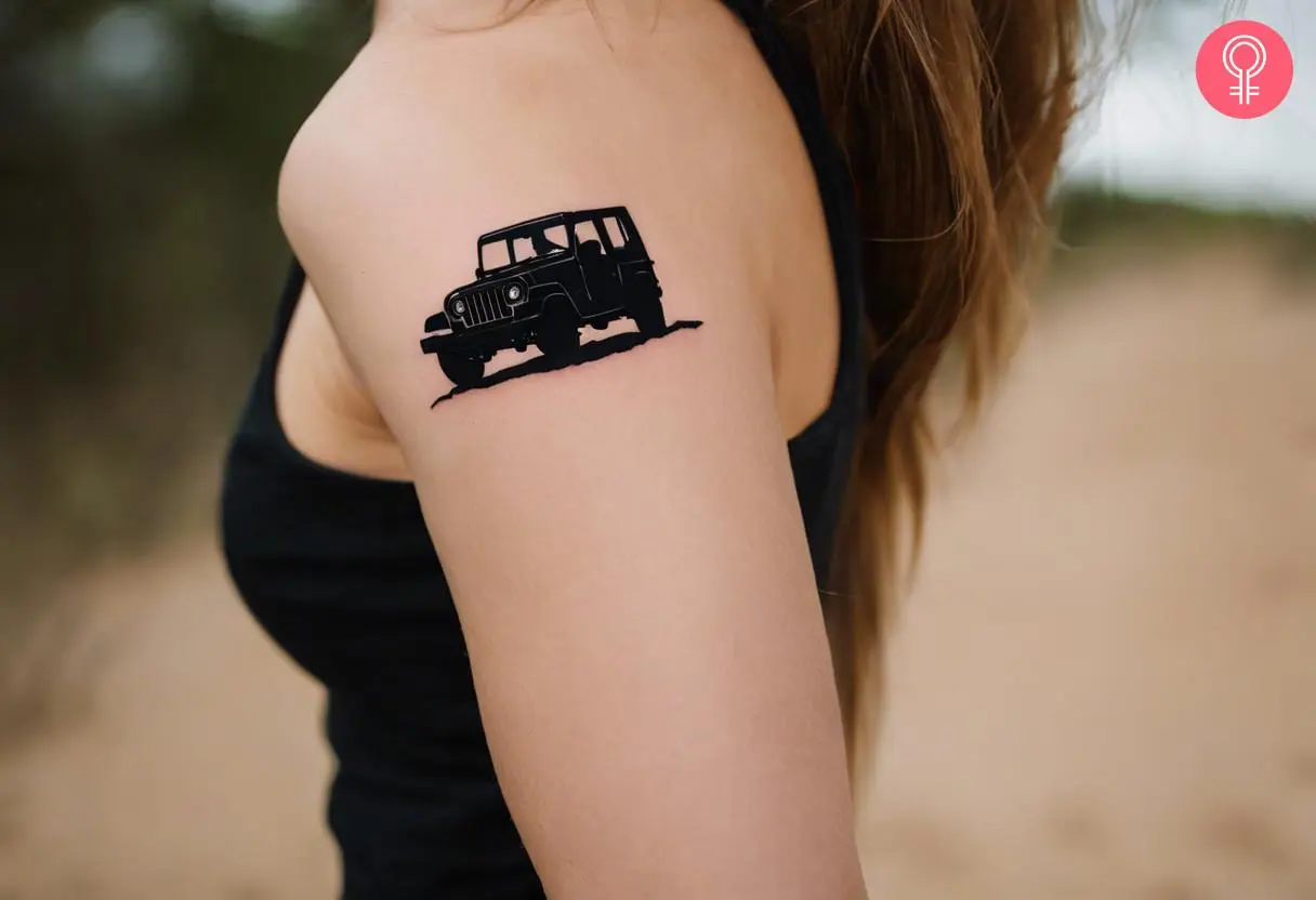 A woman with a black silhouette jeep tattoo on her upper arm