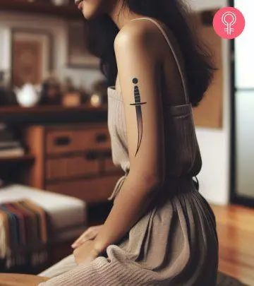 A woman flaunting a shield tattoo on the upper arm