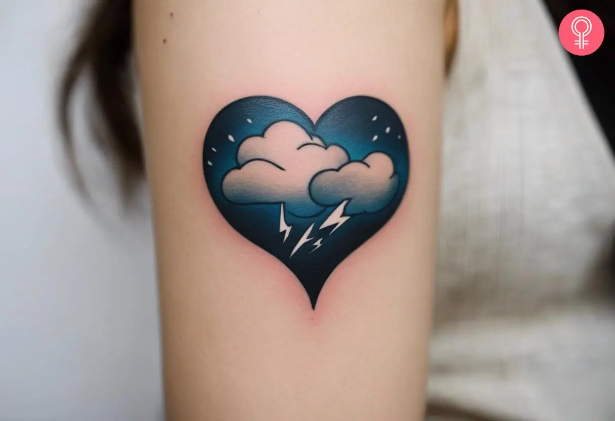 A woman with a colored thunderstorm heart tattoo on her upper arm