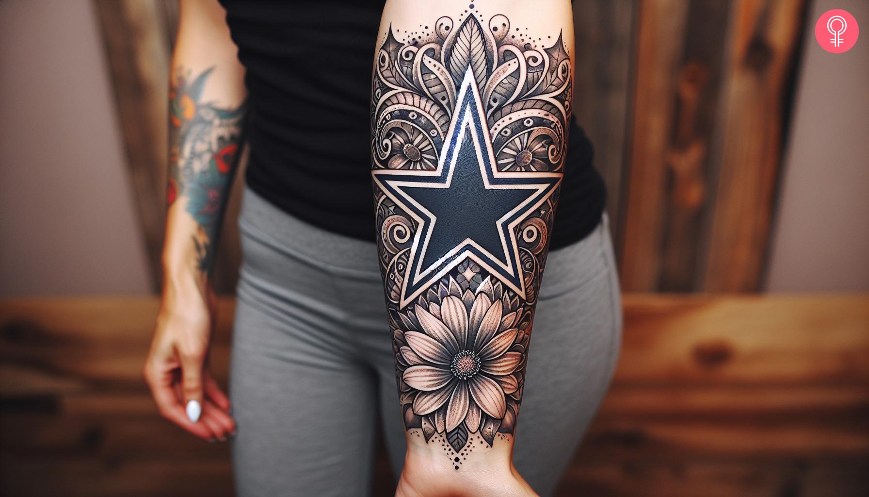 A woman with a girly Dallas Cowboys tattoo on her upper arm