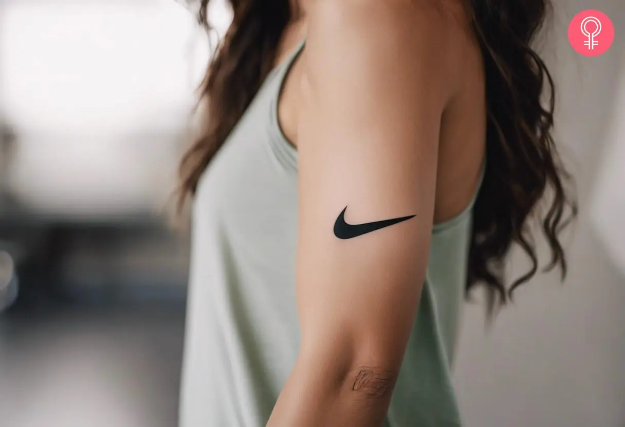 A woman with a nike tattoo on her upper arm