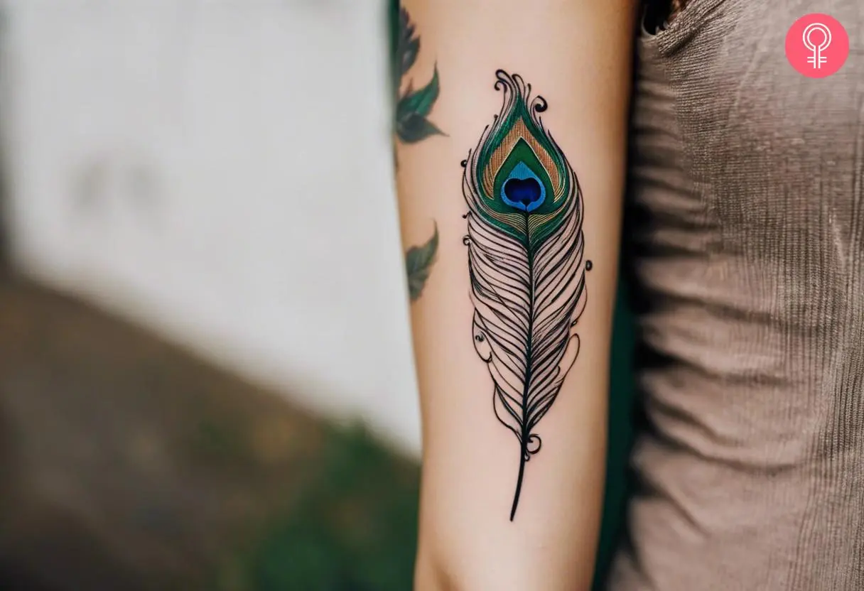 A woman with a peacock quill tattoo on her arm