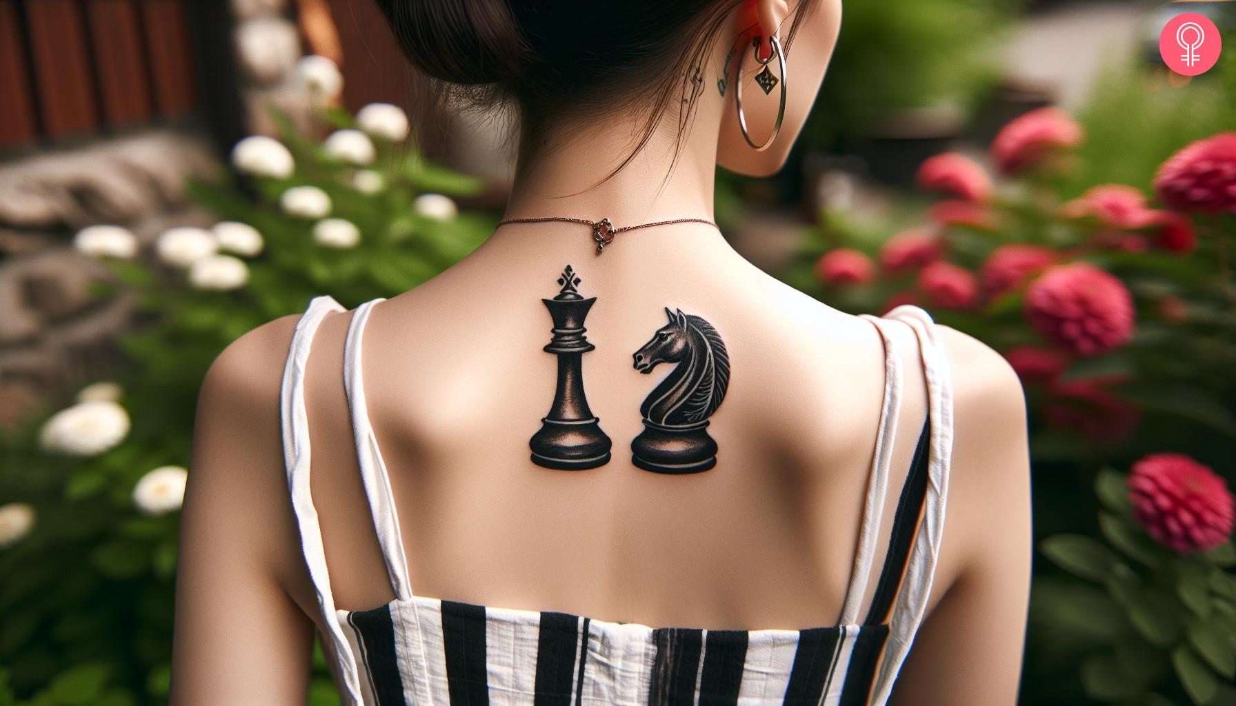 A woman with a queen and a knight tattooed on her back as chess pieces