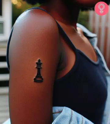 A woman with chess piece tattoo on her shoulder