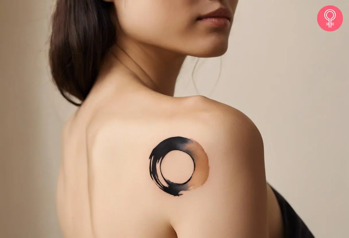 A woman with a shoulder enso tattoo