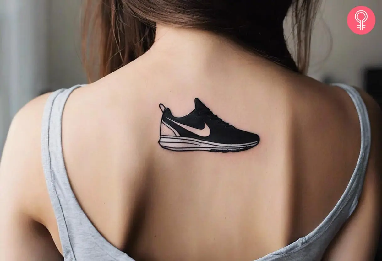 A woman with a small nike tattoo on her upper back