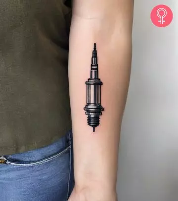 A minimalist X tattoo on a woman’s forearm