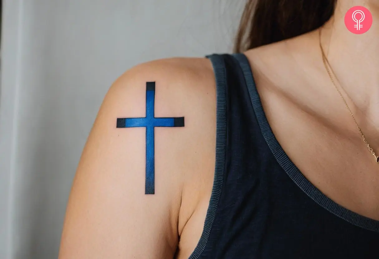 A woman with a thin blue line cross tattoo on her shoulder