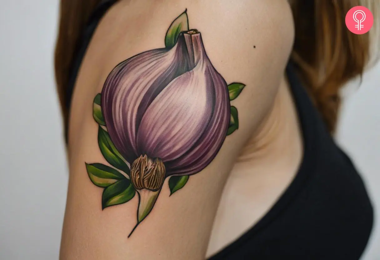 A woman with a traditional garlic tattoo on her bicep