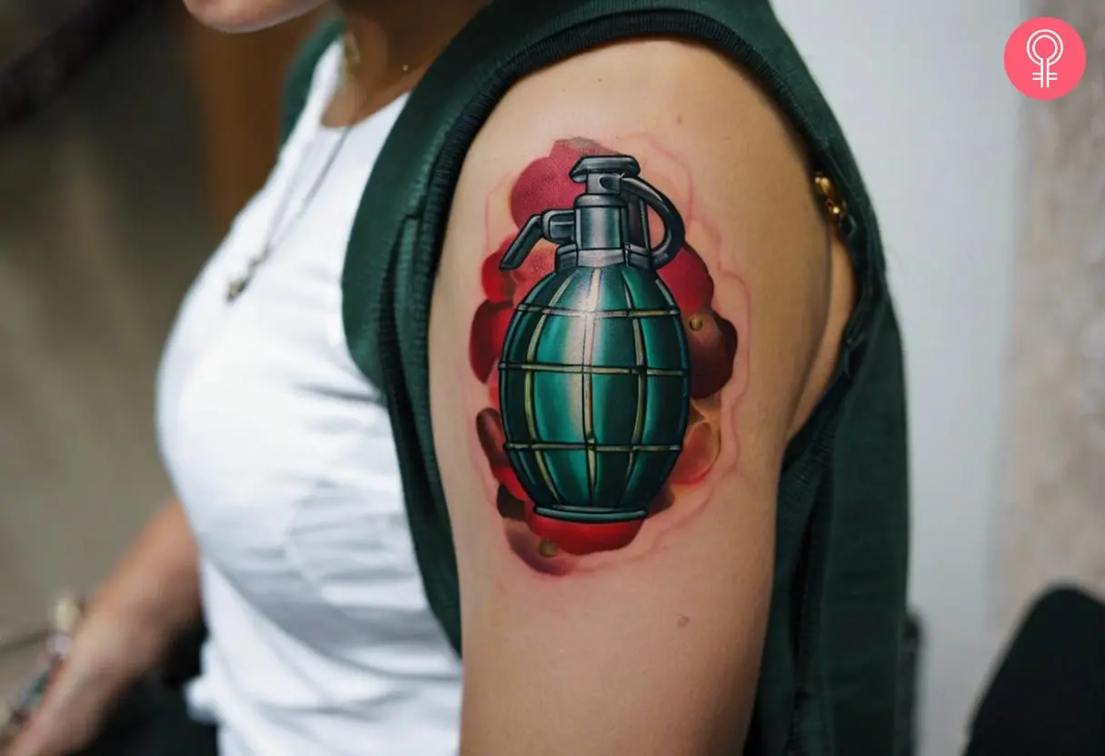 A woman with a traditional grenade tattoo on her bicep