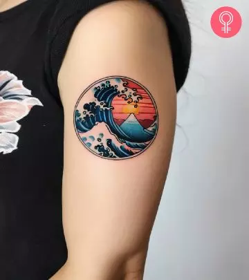 Moana tattoo on the upper arm of a woman