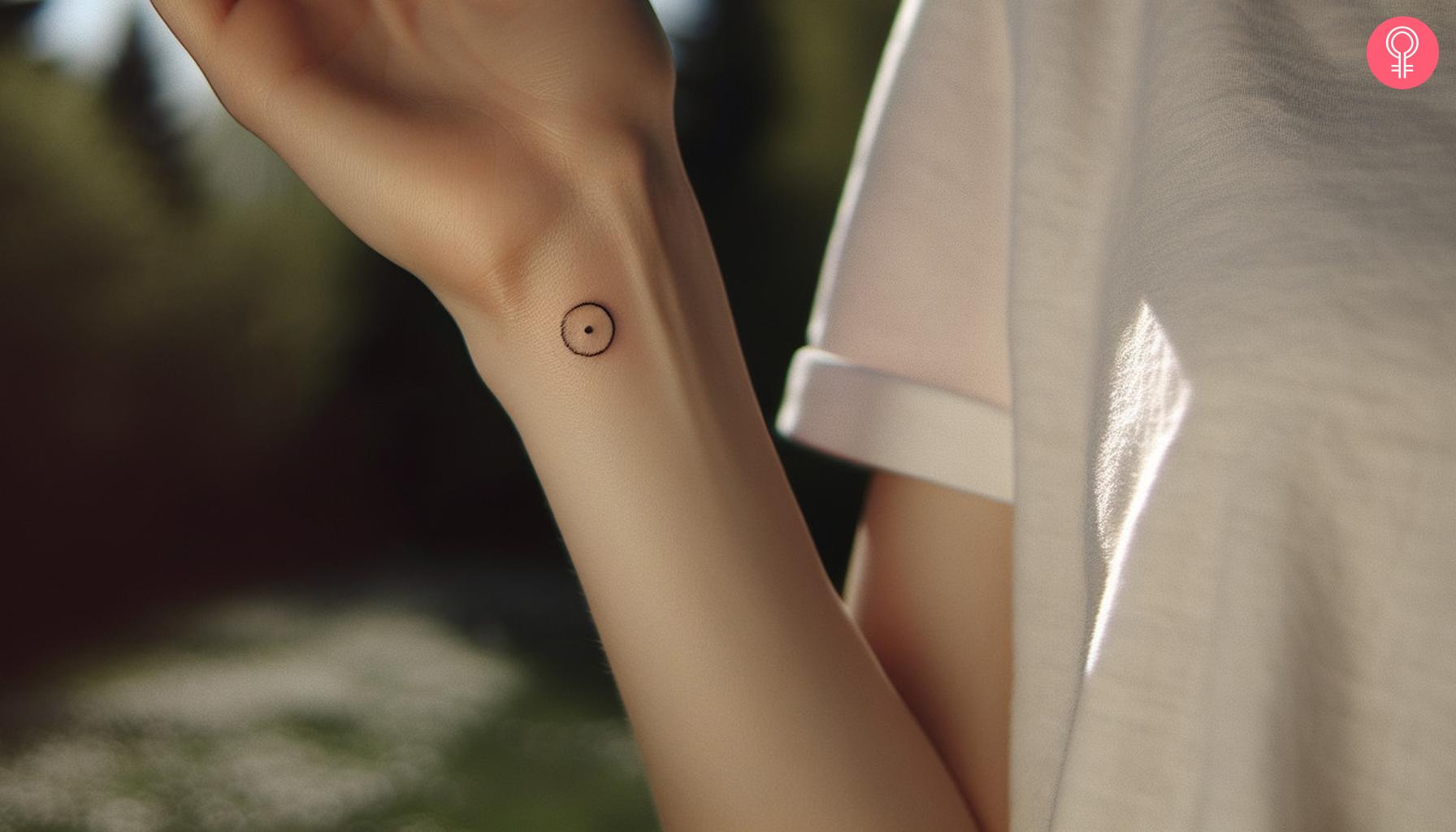 A woman with an ancient Turkish symbol tattoo on her forearm