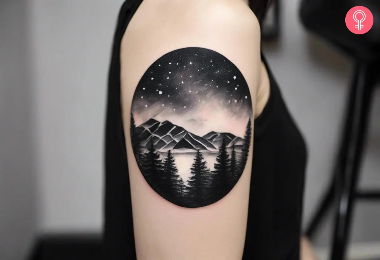 A woman with black and white aurora borealis tattoo on her upper arm