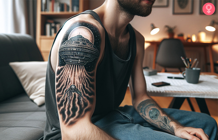 Alien spaceship tattoo on the upper arm of a man