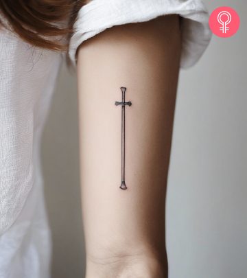 A woman with a skull and crossbones tattoo on her shoulder