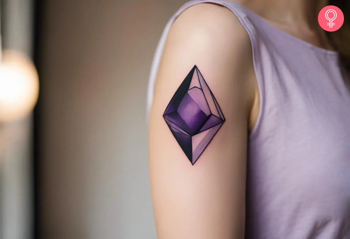 A woman with an amethyst gem tattoo on her upper arm