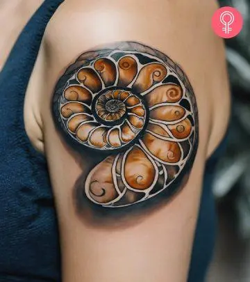 An inverted tattoo on a woman’s upper arm