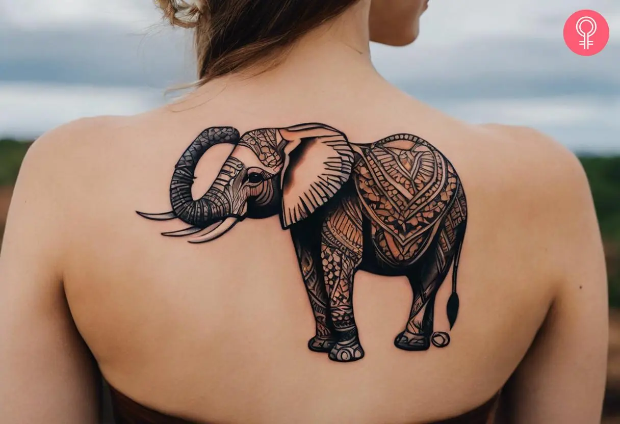 An African elephant tattoo on the woman’s upper back