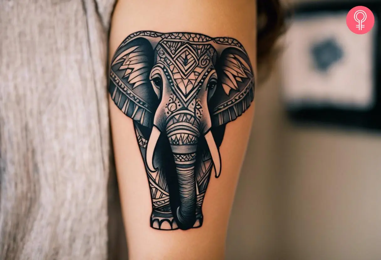 An Indian elephant tattoo on the upper arm of a woman