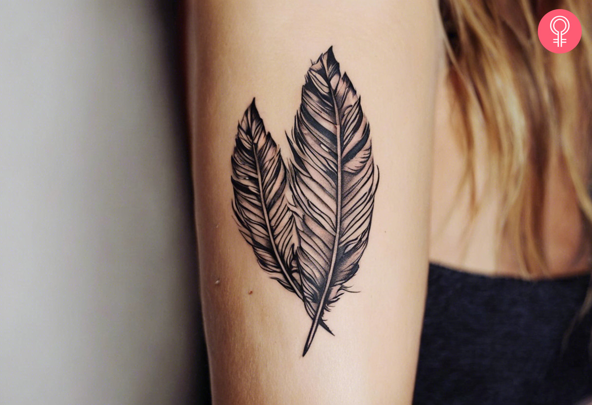 An Indian feather tattoo on the upper arm of a woman