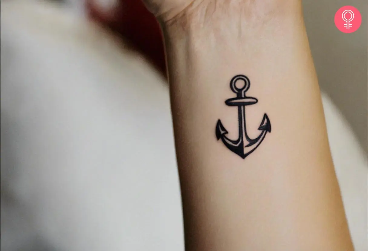 An anchor tattoo in black ink on the wrist