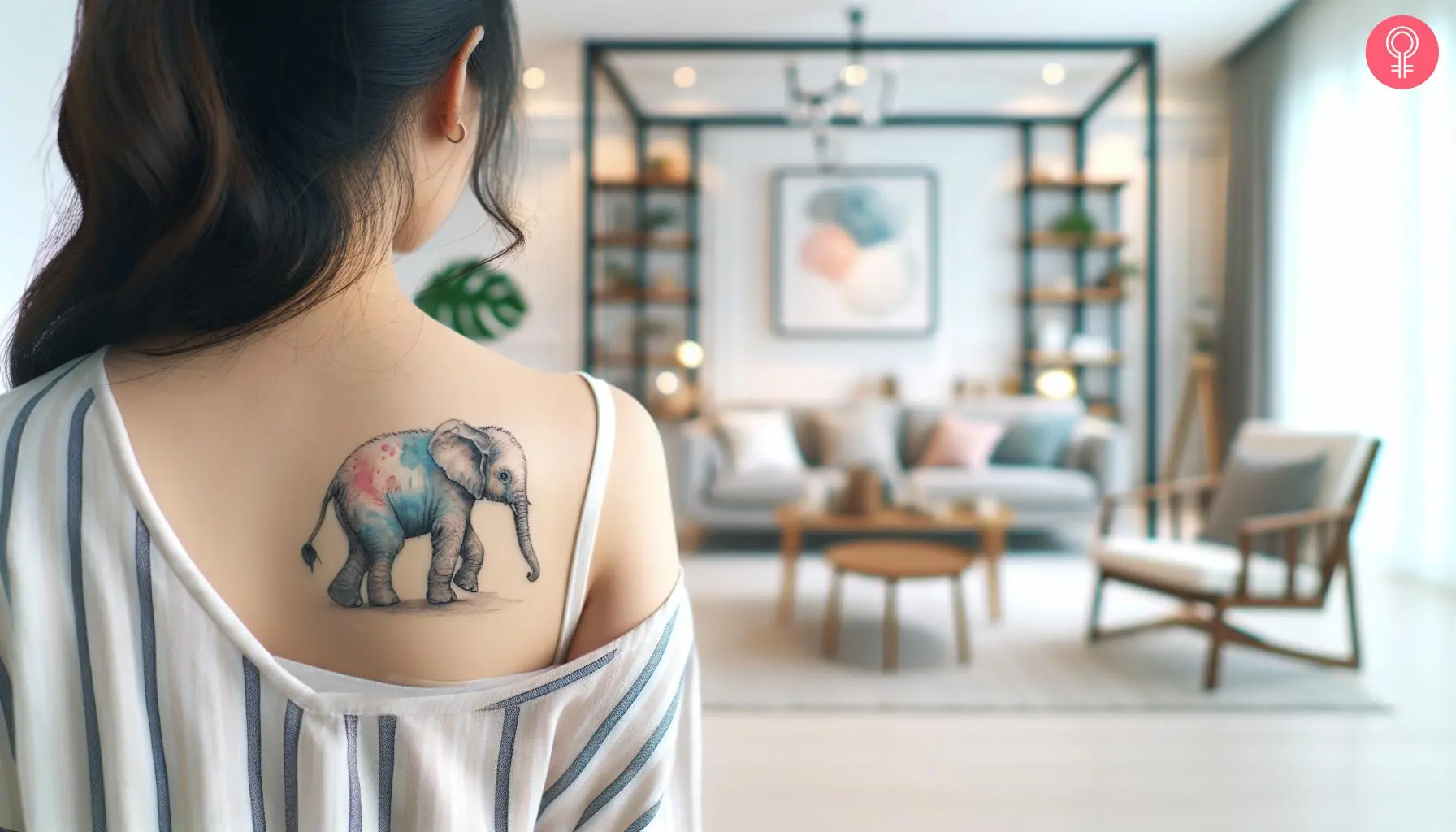 An elephant walking tattoo on the back of the shoulder