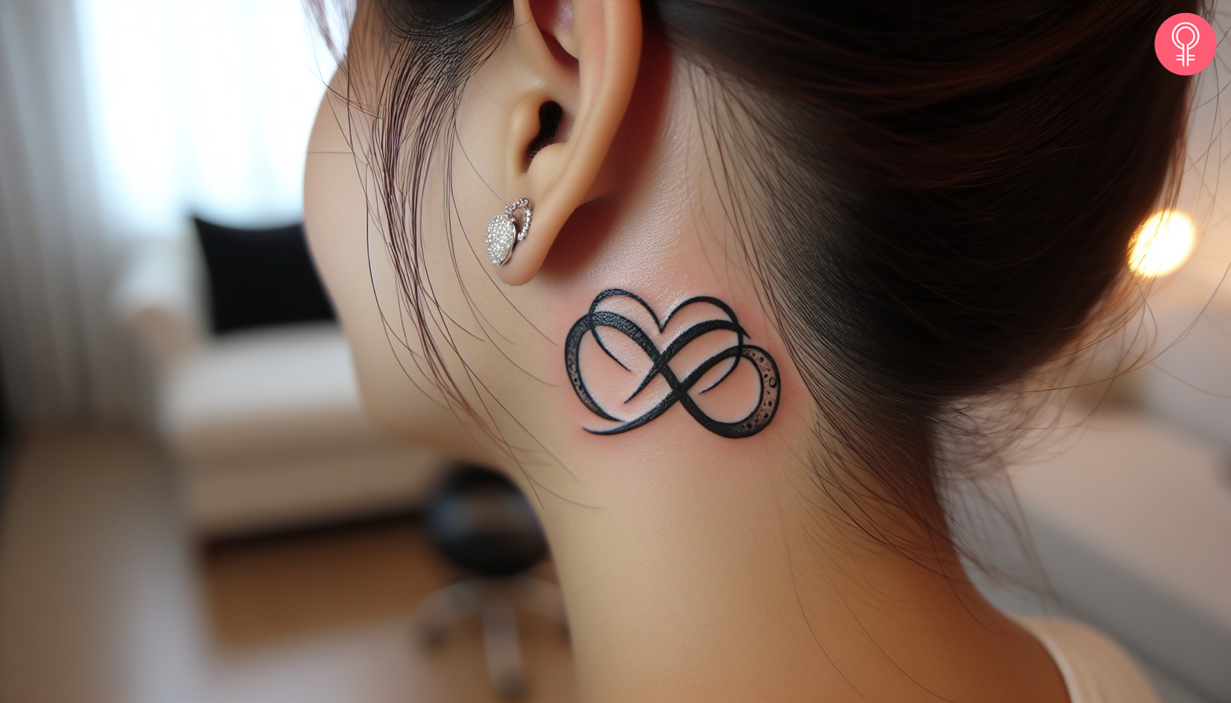 An infinity heart tattoo behind the ear