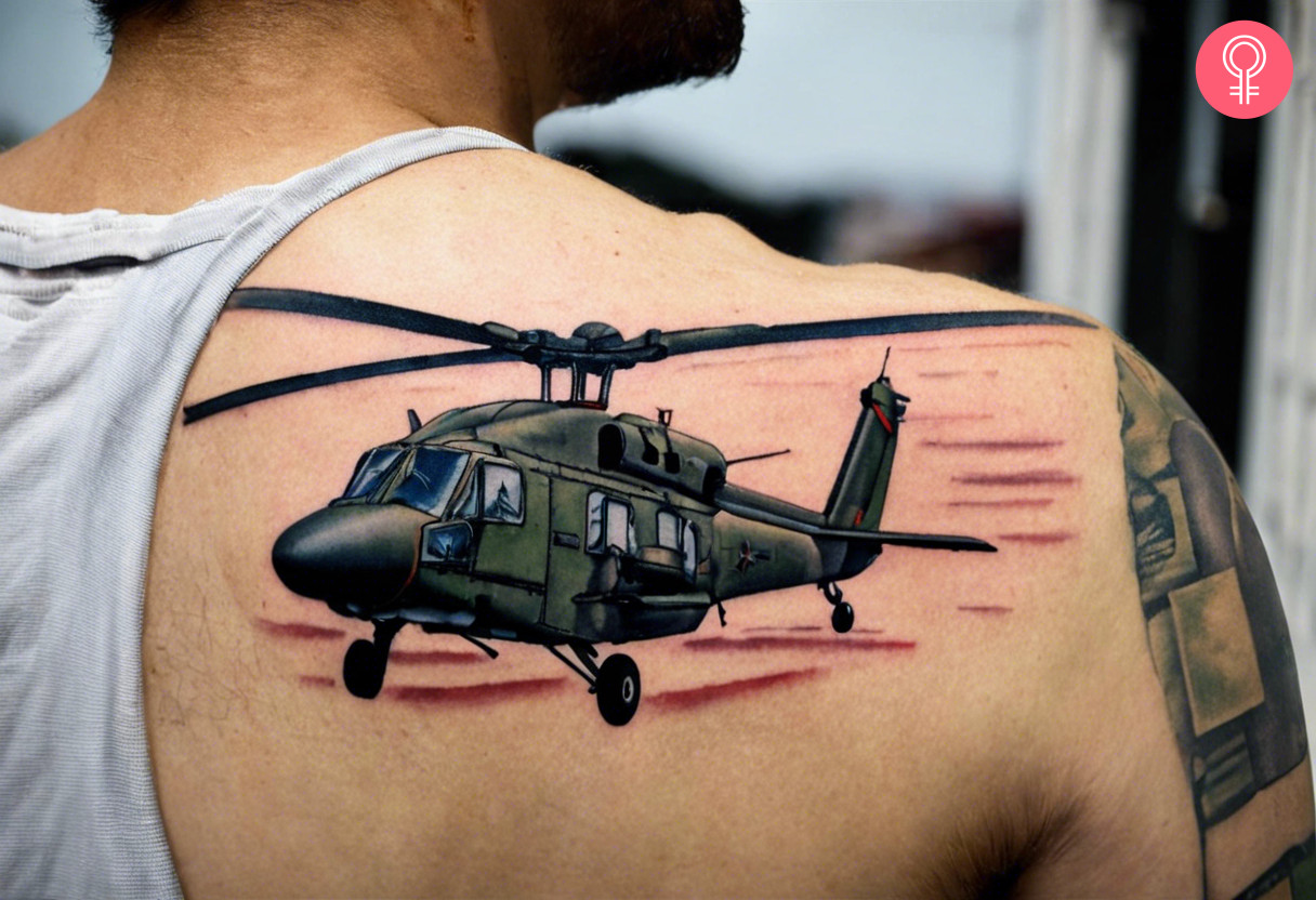 A realistic army helicopter tattoo on the back of the shoulder