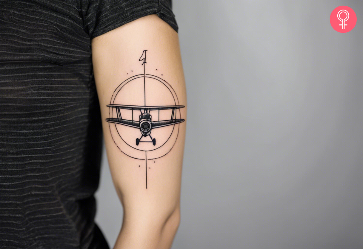 A biplane tattoo inside a circular design that points north